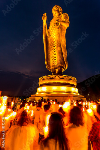 Giant golden buddha standing scenic in buddhist place at thipsukontharam temple, thailand. photo