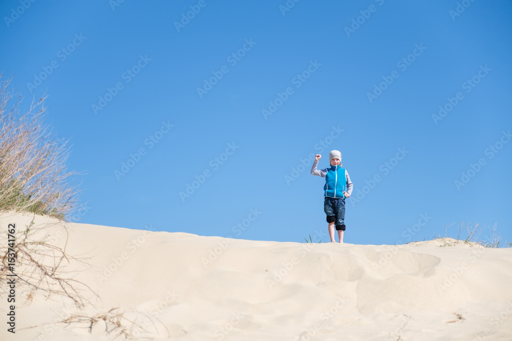 kid playing with sand in the beach