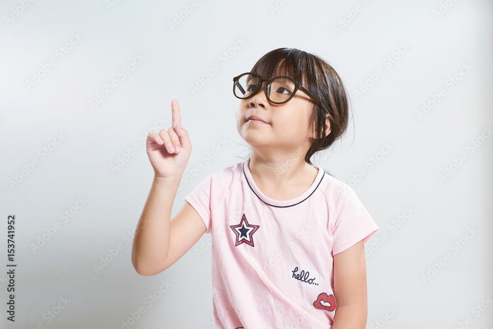 Little young cute asian girl fingers pointing up . Little young cute asian girl fingers pointing up .