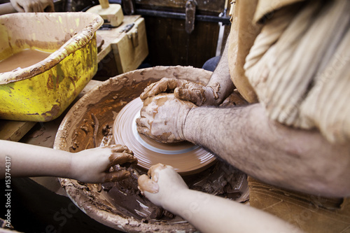 Person working clay with hands, traditional craft, potter