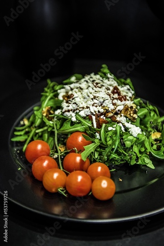 fresh salad with arugula, cheese, tomato and sauce