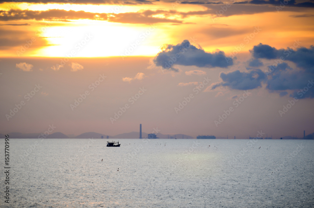 Boat in the middle of the sea with beautiful sun set