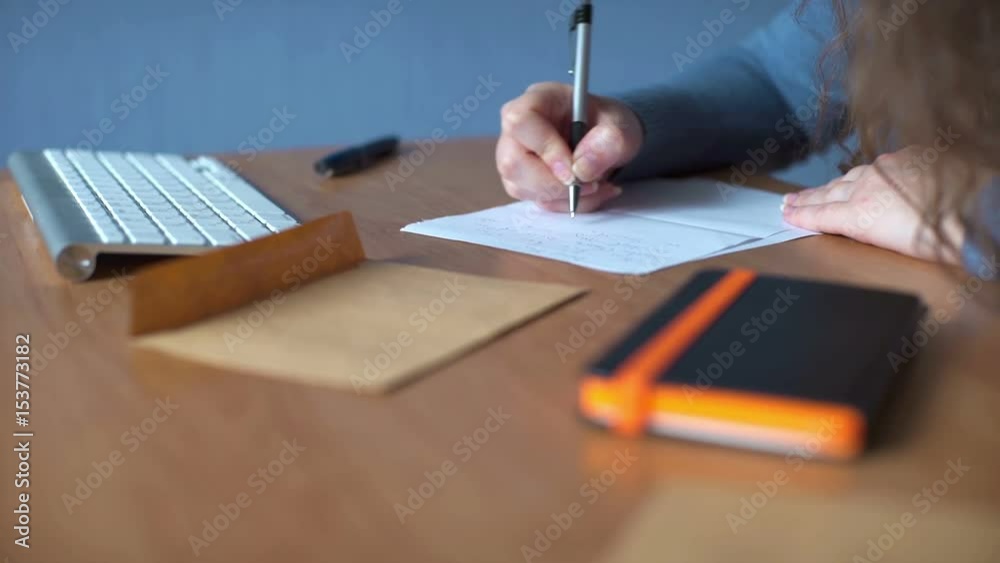 Young woman writing a letter