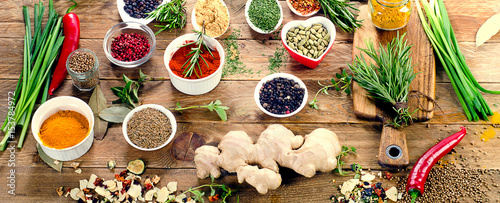 Various spices and herbs on rustic wooden background. Top view