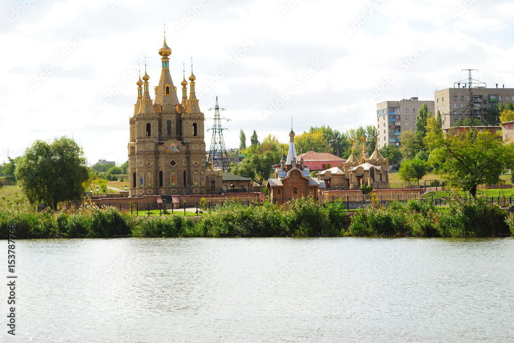 Church on the shore of the lake. Against the background of the city Church on the shore of the lake. Against the background of the city