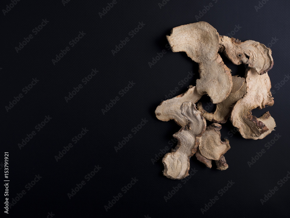 Slices of dried galangal or galanga root from Thailand isolated on black background Slices of dried galangal or galanga root from Thailand isolated on black background