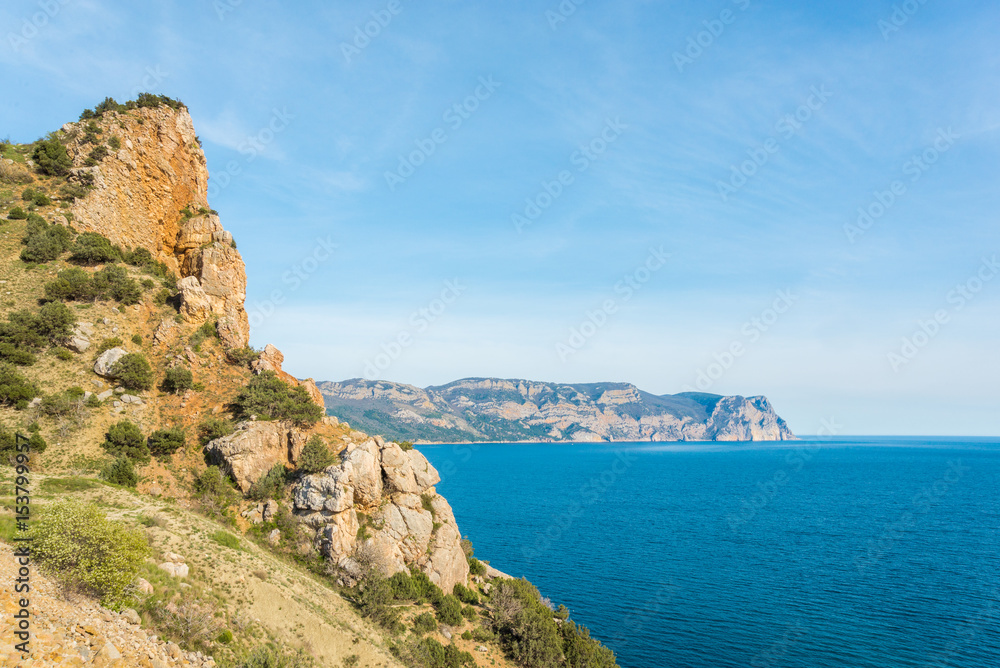 Rocky cliff above the beautiful clear blue Sea, Crimea, Balaklava