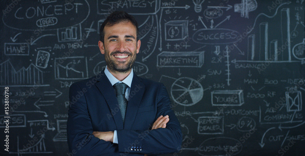 Portrait of a business man, a marketing teacher, draws a graph of success on a black board, on a black background. The concept: career growth, growth chart, successful man, marketing, ideas, finance. Portrait of a business man, a marketing teacher, draws a graph of success on a black board, on a black background. The concept: career growth, growth chart, successful man, marketing, ideas, finance.