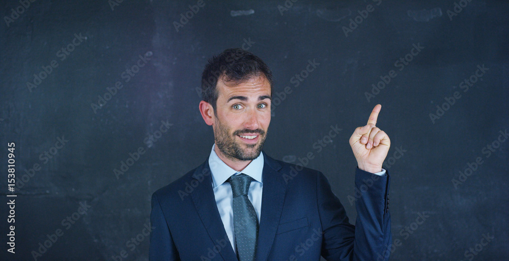 Portrait of a beautiful business man, a marketing teacher, thinking about new ideas and strategies, on a black background. Concept: career growth, growth chart, successful man, marketing, ideas. Portrait of a beautiful business man, a marketing teacher, thinking about new ideas and strategies, on a black background. Concept: career growth, growth chart, successful man, marketing, ideas.