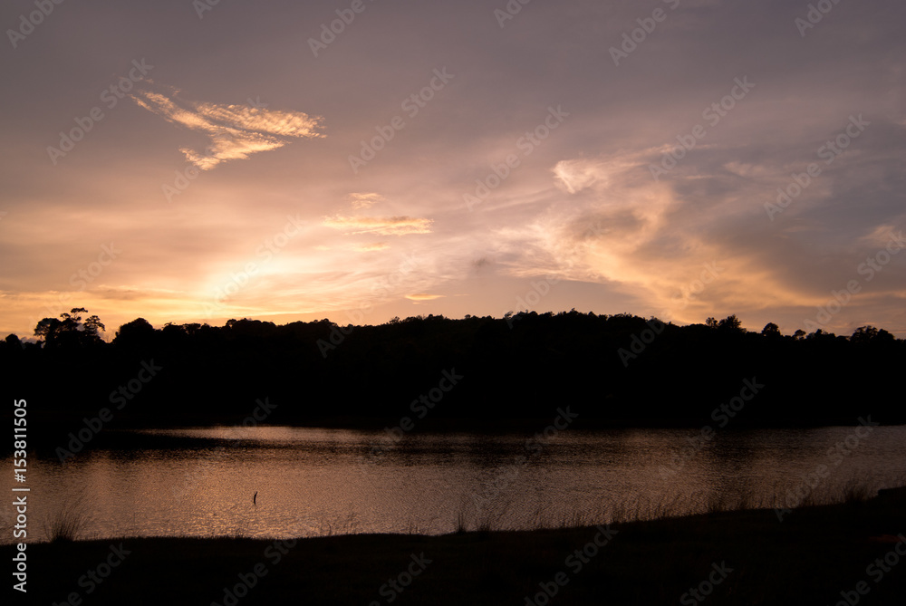 Beautiful sky landscape with sunset over river bank