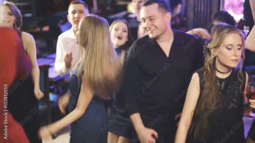 Young fun party people dancing at the night club Young fun party people dancing at the night club