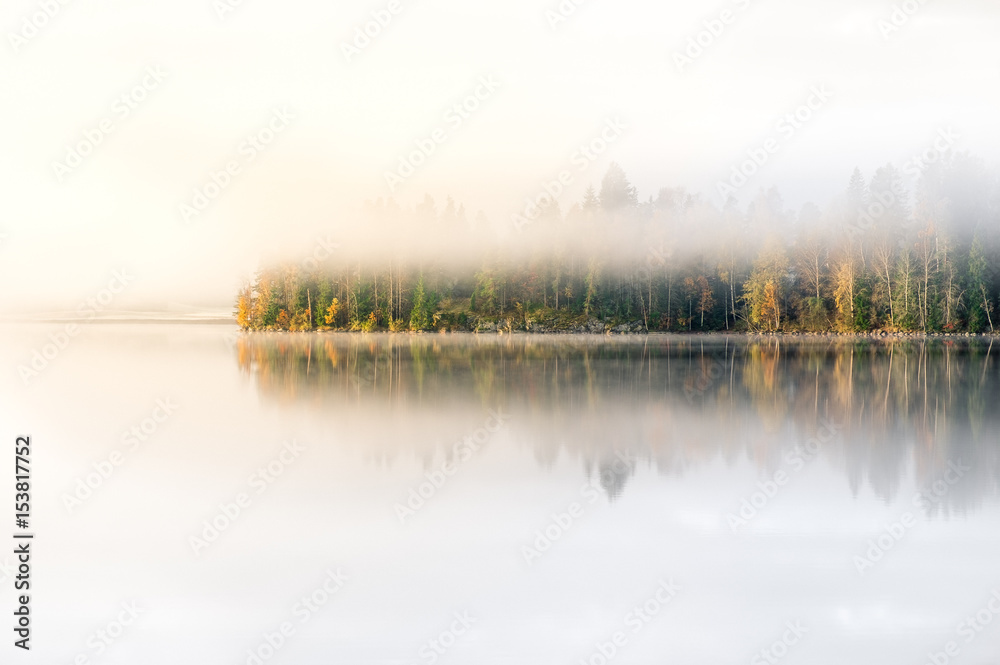 Fototapeta premium Scenic landscape with lake and fall colors at morning light