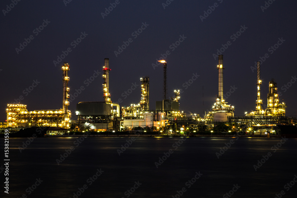 View of oil refinery industry plant in the night and river.