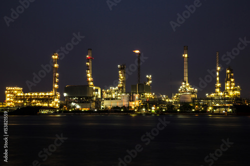 View of oil refinery industry plant in the night and river.