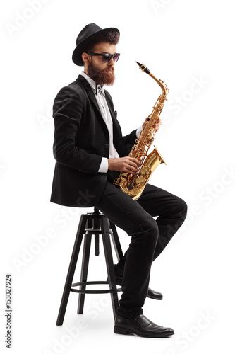Jazz musician with a saxophone sitting on a chair