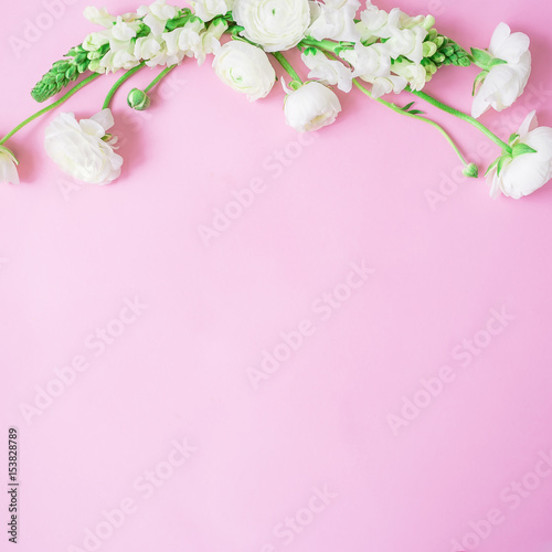 Floral frame made of white flowers on gentle pink background. Flat lay, top view. Flower pattern © artifirsov