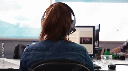 A journalist working on a computer in Newsroom