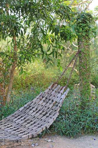 wooden cradle in garden.