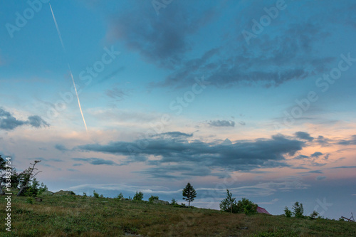 Sunset over the mountainous terrain. The nature of the Southern Urals. Sunset sky over the forest.