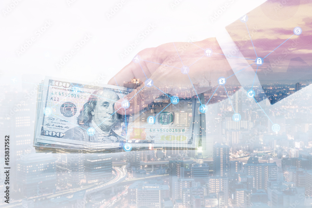 Double exposure of hand holding 100 us. dollar with cityscape Double exposure of hand holding 100 us. dollar with cityscape