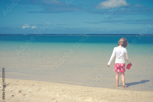 Child Plays On Tranquil Tropical Beach