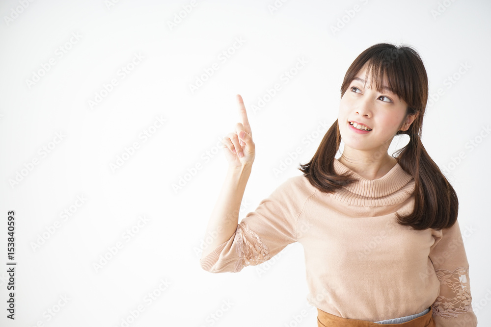 Young woman pointing something with smile Young woman pointing something with smile