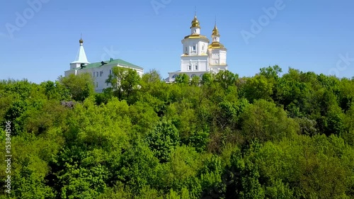 Flying near small church on a hill - aerial flight photo