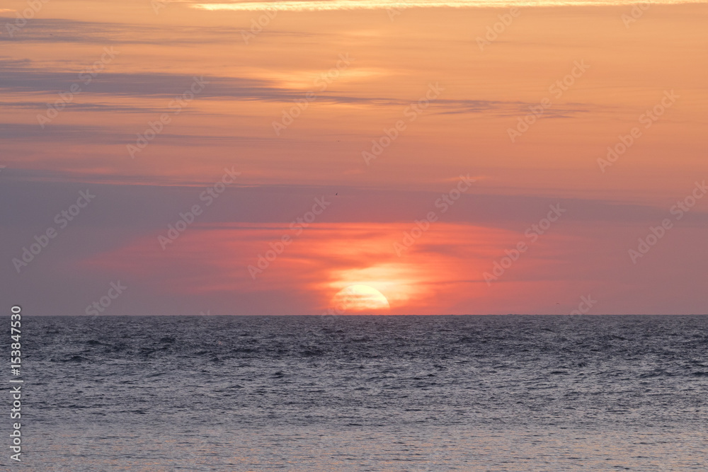 Background image of a sunset with a colorful sky at the sea (San Sebastian, Spain). Background image of a sunset with a colorful sky at the sea (San Sebastian, Spain).