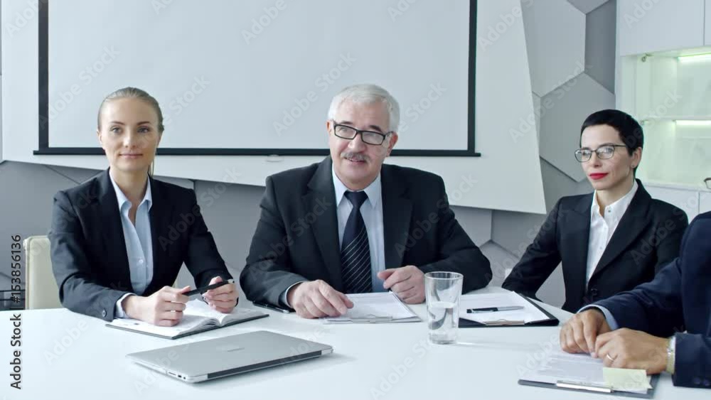 Group of professional managers interviewing new employee. Senior businessman shaking his hand and smiling Group of professional managers interviewing new employee. Senior businessman shaking his hand and smiling