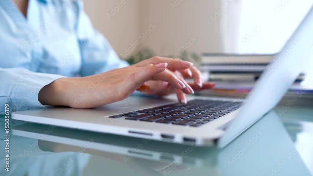 Woman office worker typing on the keyboard and works with taxes Woman office worker typing on the keyboard and works with taxes