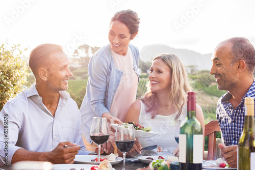 Mature couples eating outdoors
