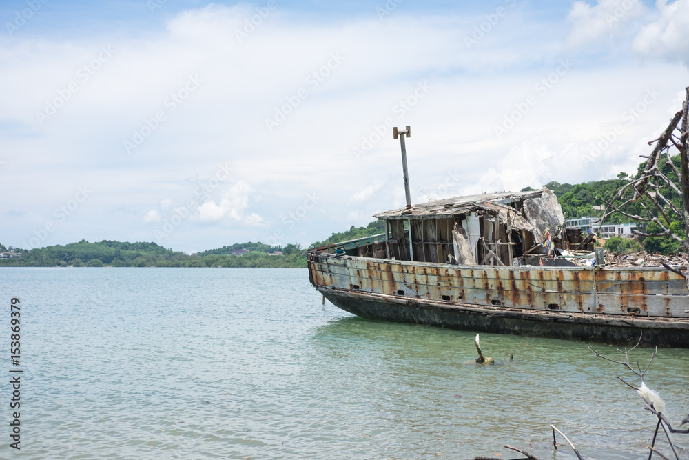 abandoned ship aground on coast and have sea cloudy sky, sea, mountain are background. this image for landscape, seascape and nature concept abandoned ship aground on coast and have sea cloudy sky, sea, mountain are background. this image for landscape, seascape and nature concept