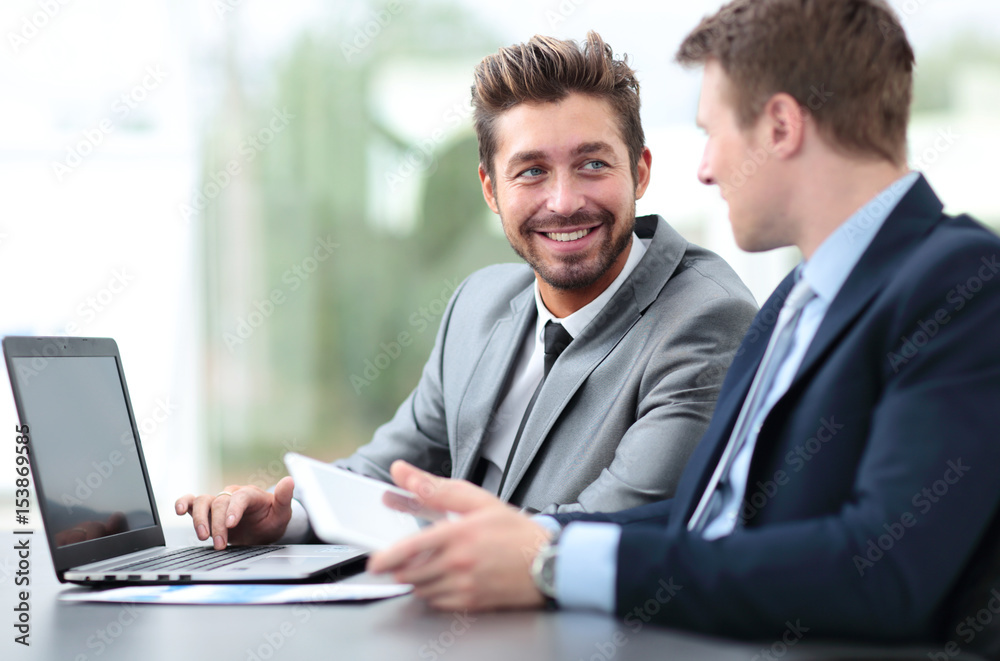 Two handsome businessmen working together on a project in the of Two handsome businessmen working together on a project in the of