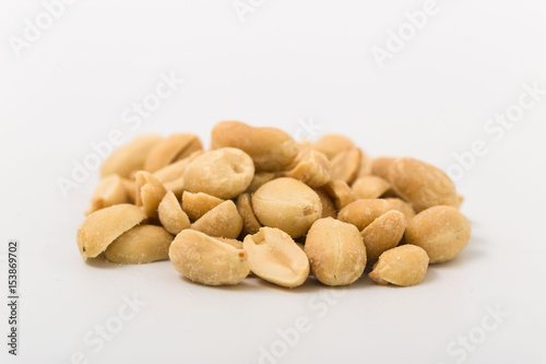 Fried salted peanuts on white background. snack.