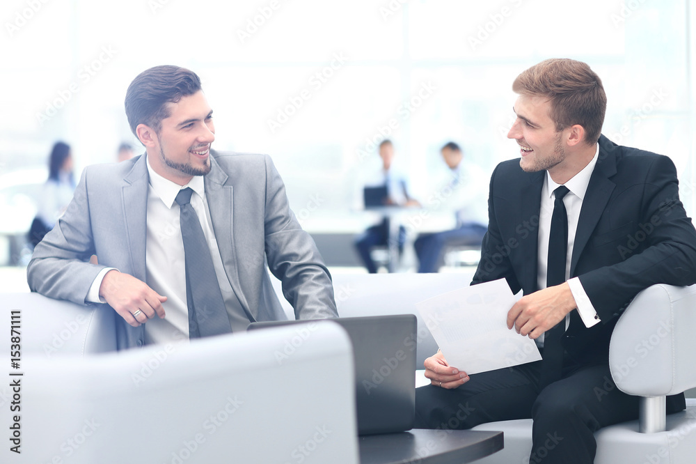 Image of business partners discussing documents and ideas at mee Image of business partners discussing documents and ideas at mee