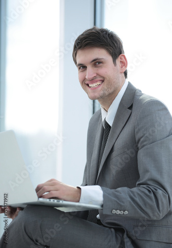 Happy young business man work in modern office on computer © ASDF