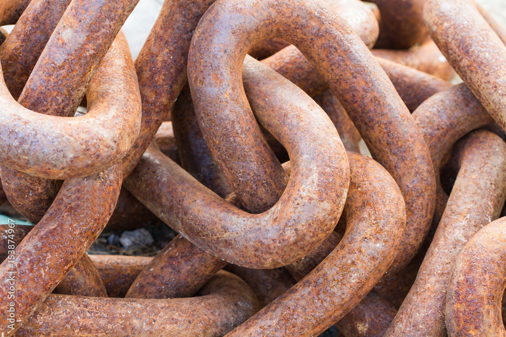 A full frame image of thick, heavy industrial chains that are rusty, weather and worn an industry background image. A full frame image of thick, heavy industrial chains that are rusty, weather and worn an industry background image.