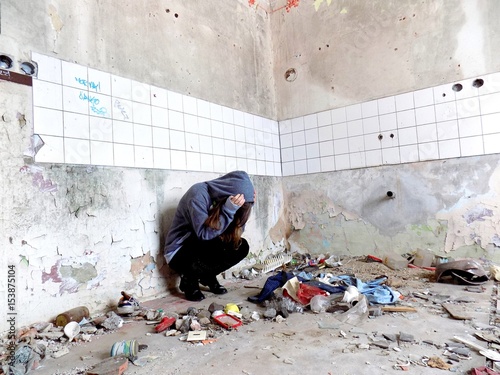 Sitting women in depression, young sadness women crying in old dirty abandoned house