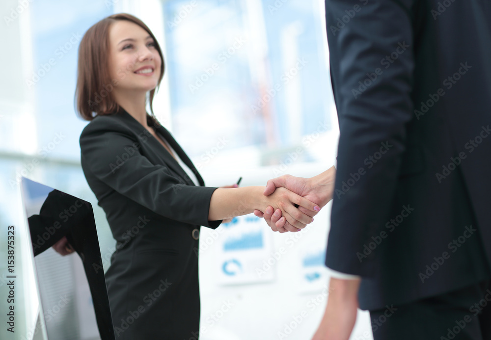 Business handshake. Two business people shaking hands in office. Business handshake. Two business people shaking hands in office.