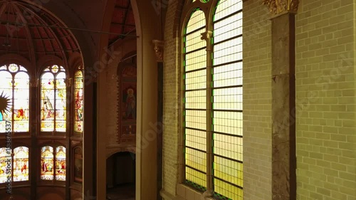 Aerial slider shot in a Church along the stained windows photo