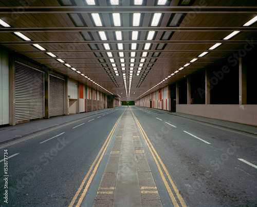 Illuminated road in parking structure photo