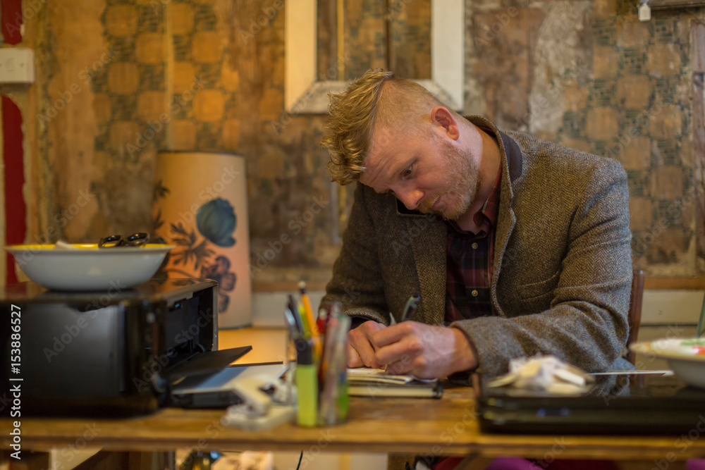 Businessman taking notes at desk Businessman taking notes at desk