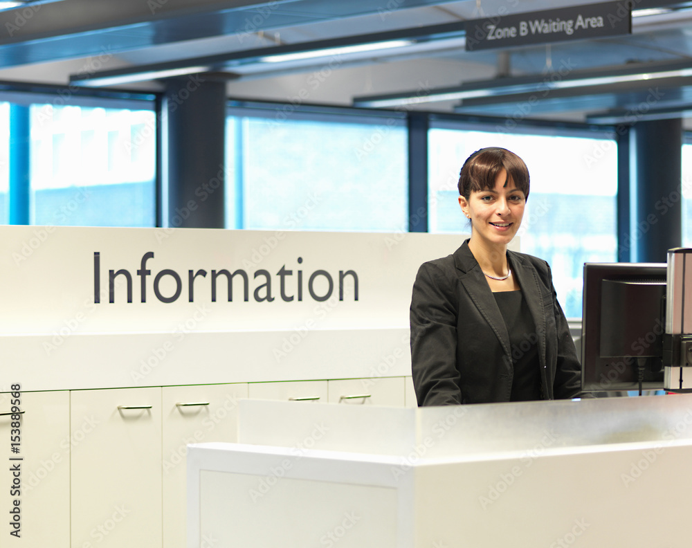 © Connect Images - Receptionist smiling at information desk © Connect Images - Receptionist smiling at information desk