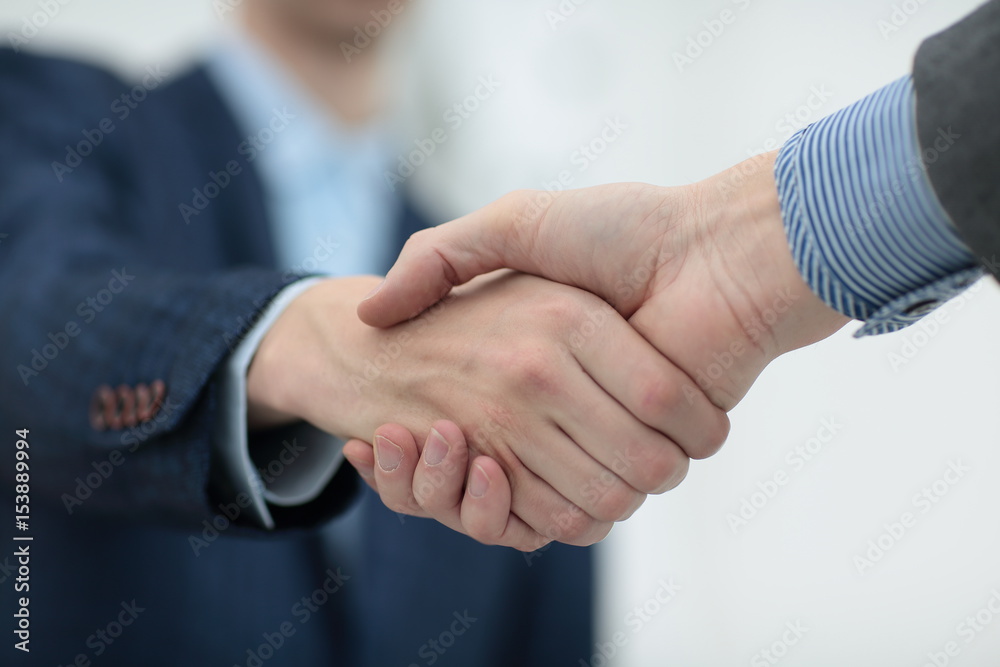 businessman shaking hands to seal a deal with his partner businessman shaking hands to seal a deal with his partner
