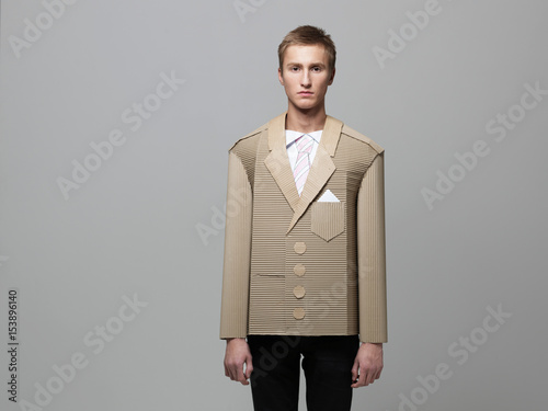 Man wearing jacket made out of corrugated cardboard photo