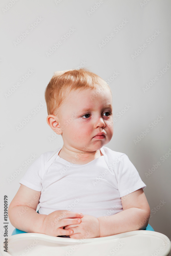 Baby boy sitting in high chair Baby boy sitting in high chair