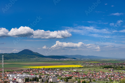 Spring view over Rasnov city, in Brasov county (Romania), with Codlea mountain in the background and with Cristian village in the far right © Creatikon Studio