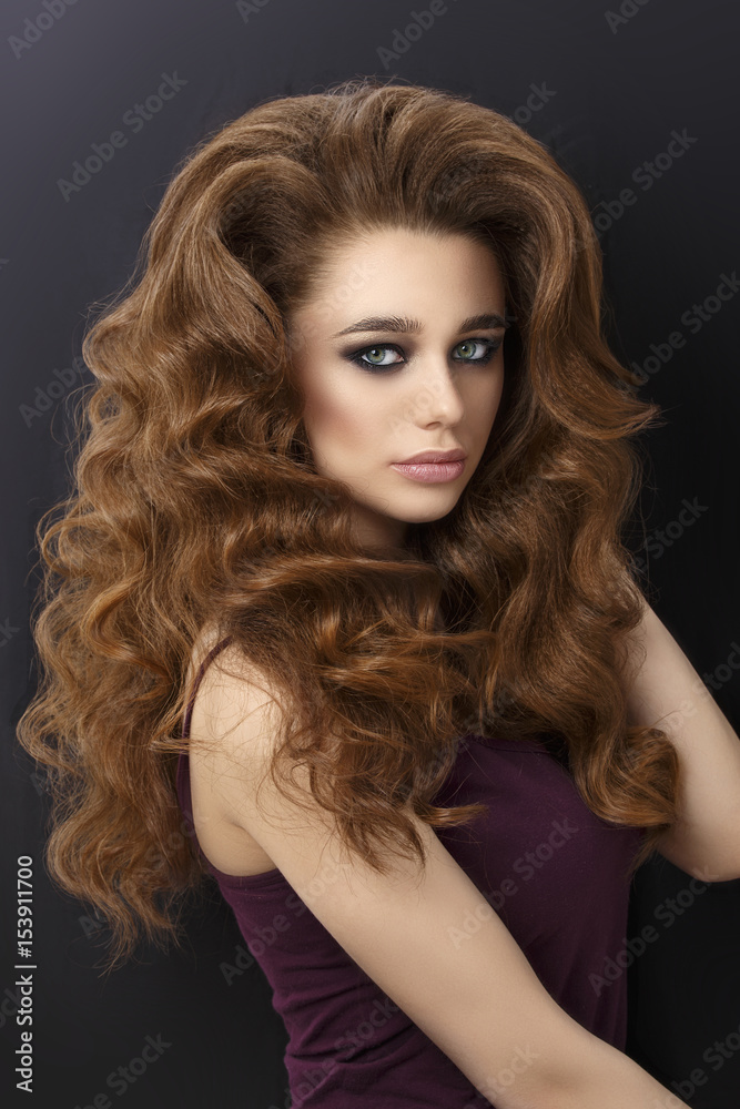 Beautiful girl with green smokey eyes and hair curls