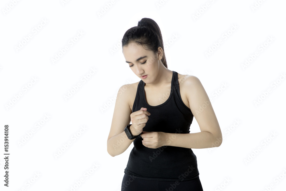 Pretty female wearing a smartwatch on studio Pretty female wearing a smartwatch on studio