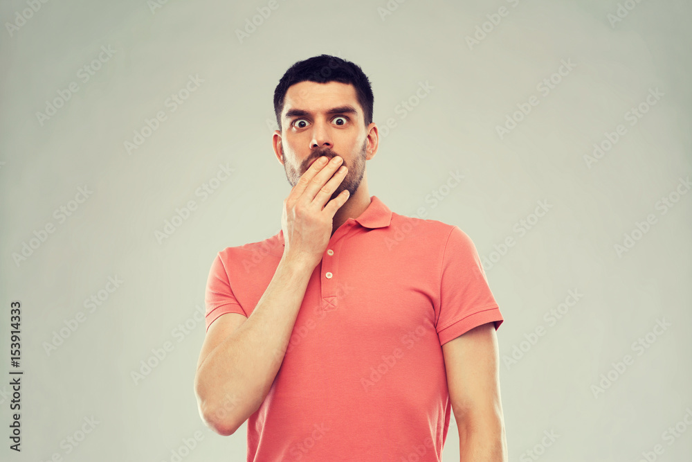 scared man in polo t-shirt over gray background scared man in polo t-shirt over gray background